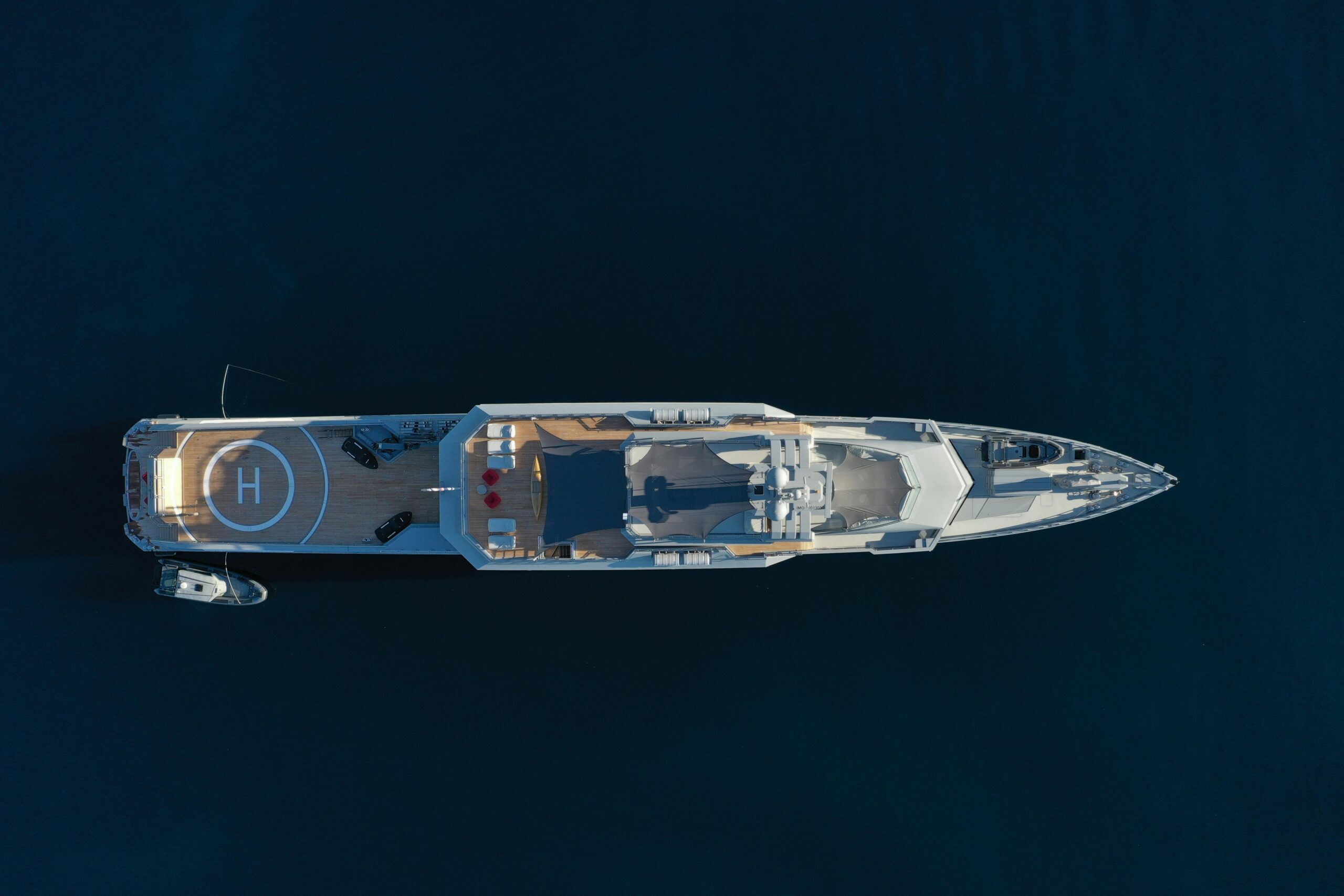 Stunning drone shot of a luxury yacht in Sardegna, Italy's serene waters.