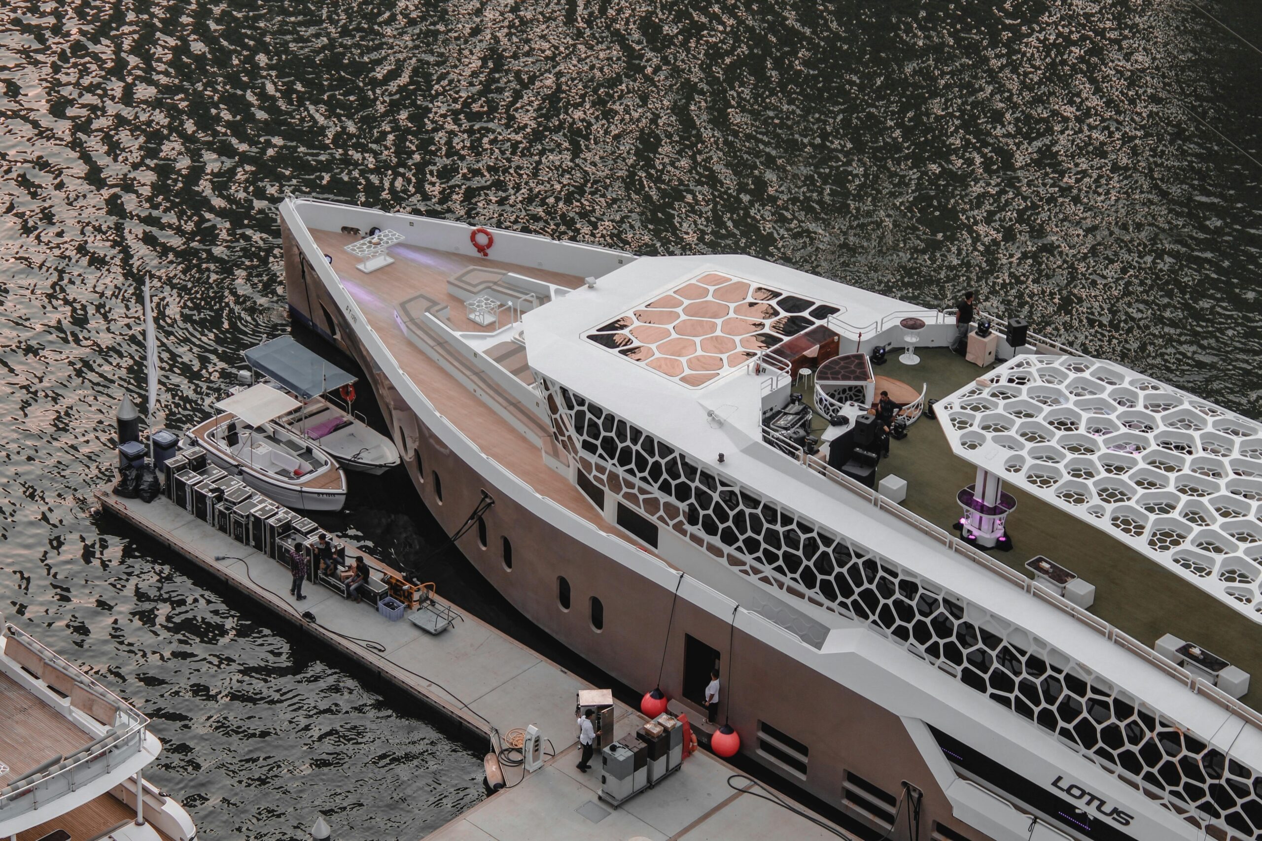 Luxury yacht docked at Dubai Marina, showcasing modern design and waterfront elegance from an aerial perspective.